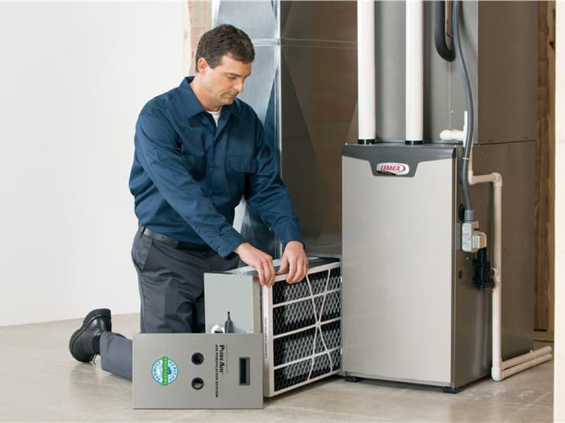 HVAC technician performing a furnace and AC system inspection in Phoenix, AZ